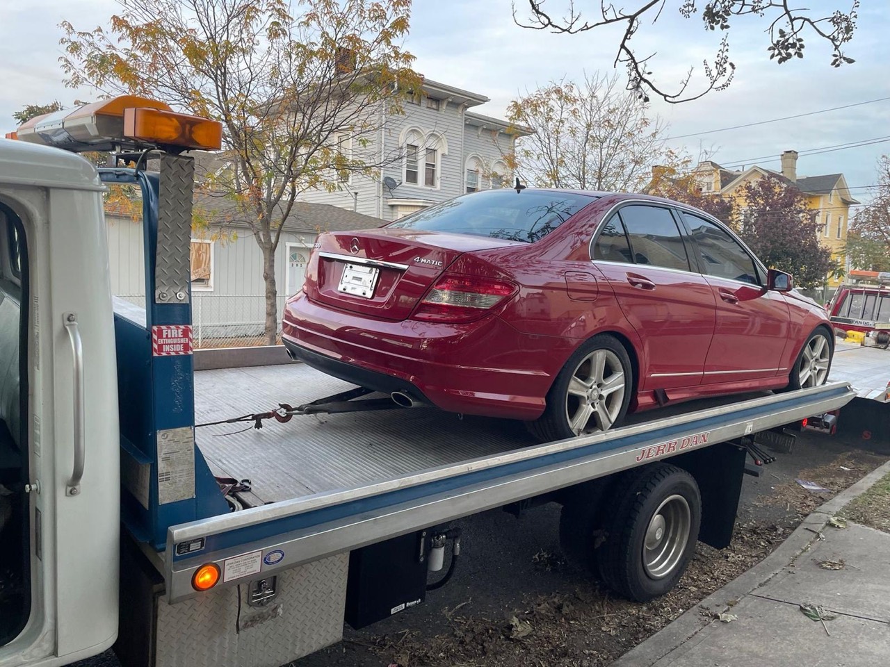 Mercedes sedan on flatbed truck